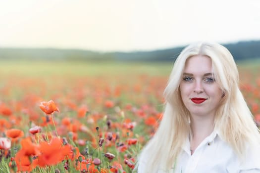 Portrait of smiling blonde woman posing in red poppy field.  Horizontally.