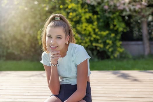 Cute tanned girl is posing by the pool closeup.  Horizontally.