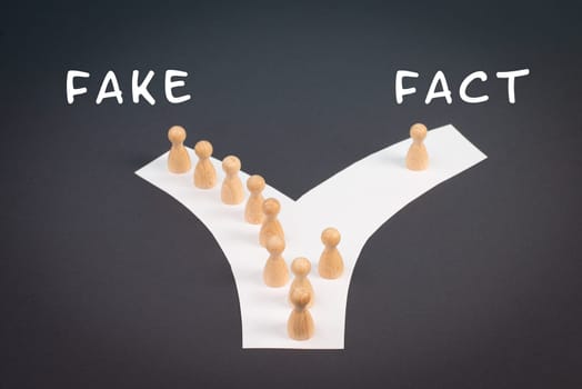 Crowd of people follow the path to the fake information, one thinks different and takes his own way and decisions, propaganda and conspiracy theory concept, media and manipulation issue