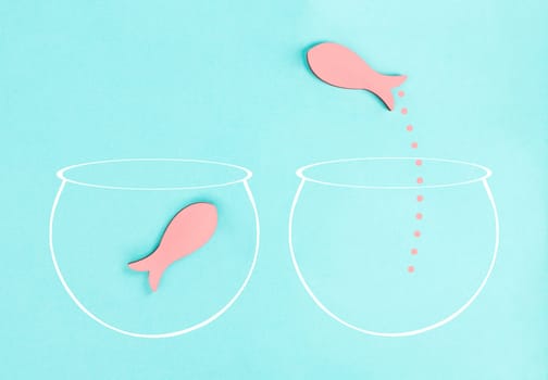 One fish is the leader of the group, leadership and teamwork concept, be a winner, success and start up in business, follow a new idea, fishes in a aquarium jump to freedom