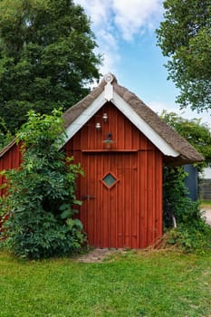 Wooden tool shed with thatched roof