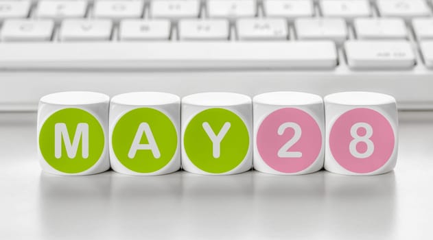 Letter dice in front of a keyboard - May 28