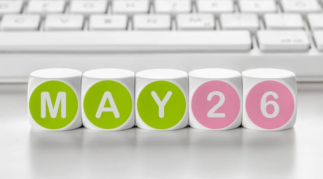 Letter dice in front of a keyboard - May 26