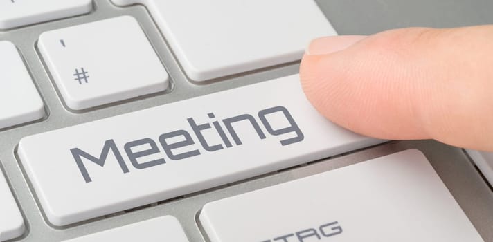 A keyboard with a labeled button - Meeting