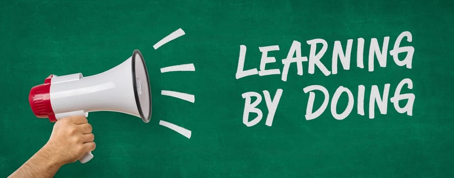 A man holding a megaphone - Learning by doing