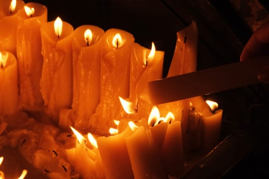 Lighting candles in chapel of Our Lady from the Kamenita vrata (Stone Gate) in Zagreb to remember and honor the deceased loved ones