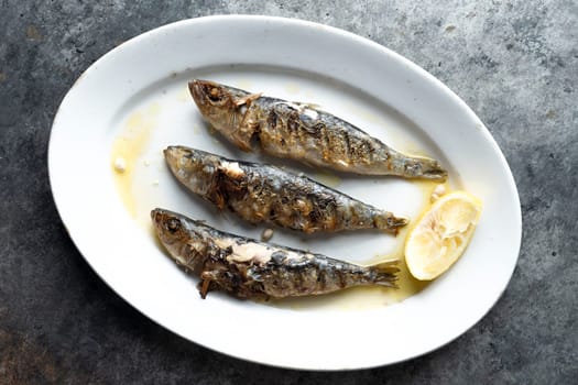 close up of plate of grilled sardines