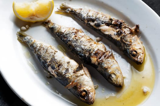 close up of plate of grilled sardines
