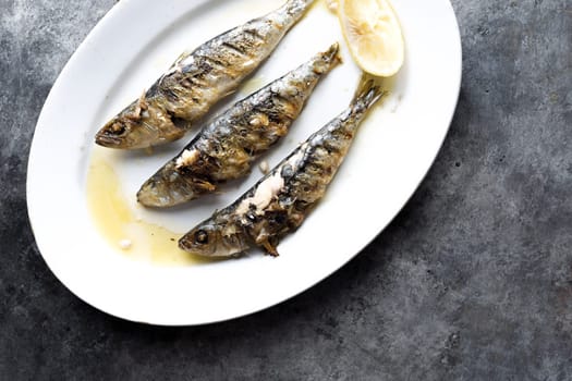 close up of plate of grilled sardines