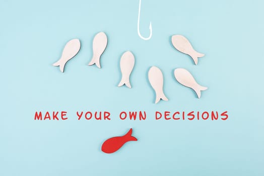 Group of fishes swimming to the fishing rod, red fish makes his own decision and takes a different direction, against the stream symbolic, courage and winner concept