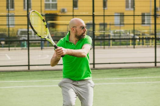 young man play tennis outdoor on tennis field at early morning