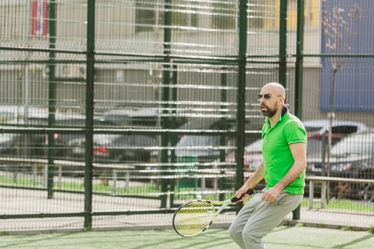 young man play tennis outdoor on tennis field at early morning