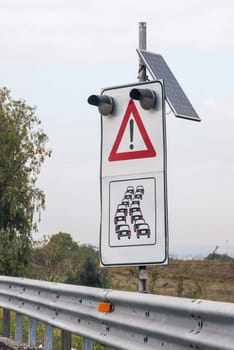 Signpostin with photovoltaic panel on the highway