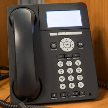 a phone in the office with dial buttons