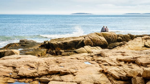 Acadia National Park, ME, October 5, 2020: Elderly couple enjoying a beautiful day on the Atlantic coast of Acadia National Park