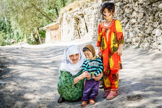 August 26, 2016, Margib village, Tajikistan: Local children with their grandmother in a small village in Yaghnob region of Tajikistan