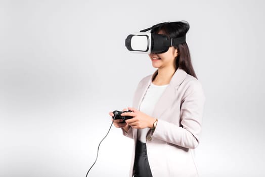 Smile woman confidence excited wear 3D VR headset device and playing game virtual reality experience with joystick isolated white background, Asian happy female play video game studio shot,copy space