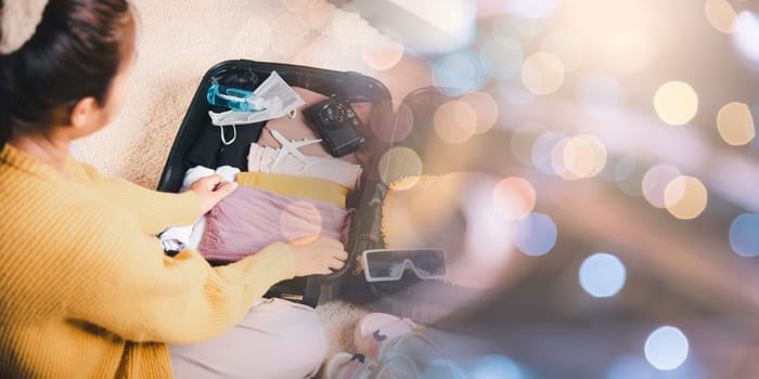 Preparing for travel in new normal. Woman packing clothes in luggage for new journey, Preparation travel suitcase at home, Travel vacation traveling after quarantine coronavirus pandemic concept