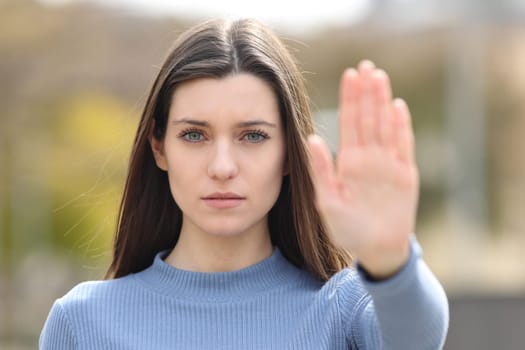 Angry teen gesturing stop in a park