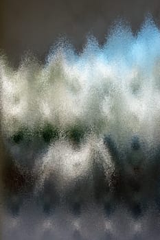 Frosted glass texture. Colorful lights background.