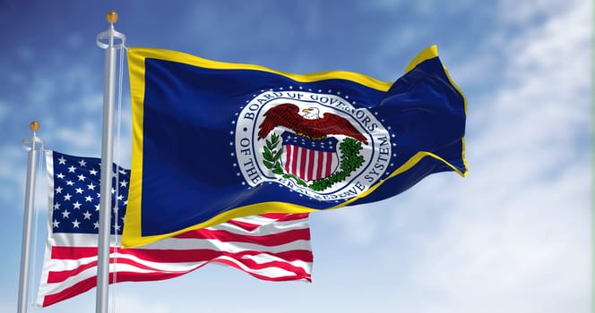 Washington D.C., USA, March 2022: The flag of the American Federal Reserve System waving in the wind with the flag of the United States blurred in the background.