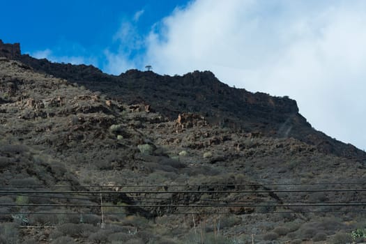 Mountains on the coast between Puerto de Mogan and Puerto Rico. Layers of volcanic rock.