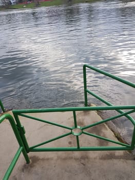 Flood on the river with a dock made of concrete