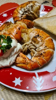 Traditional spanish tapa with prawns cooked in oil with garlic and chili. Served with slice baguette