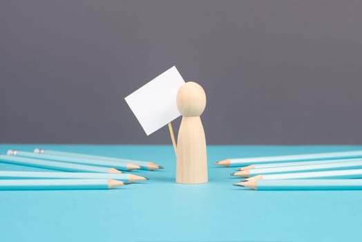 Man with an empty sign, blue pencils point to the person, business and education concept, cancel culture and free speech, journalist