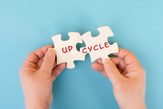The word up cycle is standing on puzzle pieces, environmental conversation, reuse and repair concept, responsibility with resources, zero waste