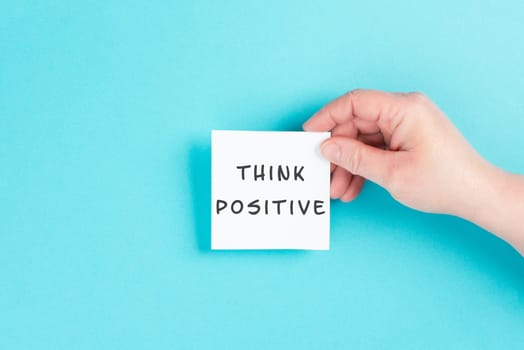 The words think positive are standing on a paper, optimistic mindset, coaching and motivation concept, attitude for success