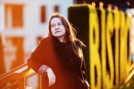 Businesswoman in the street at sunset. Portrait of elegant woman in an urban setting. Selective focus.