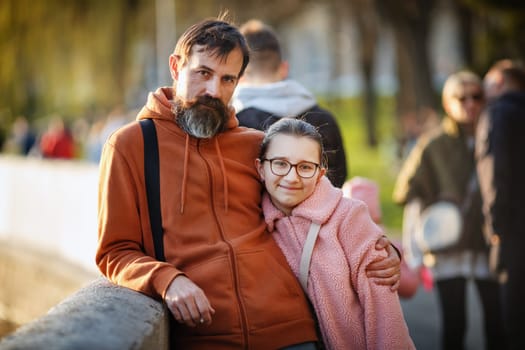 Portrait of a teenage daughter with dad outdoors. Selective focus on the girl.