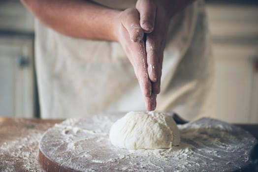 Man baking bread in the kitchen.