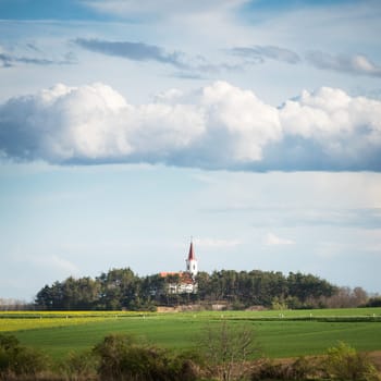Austria Burgenland Village of Lackendorf with church and dramatic clouds