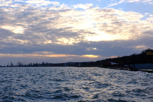 Sunset in azov sea with view on Port Mariupol, Ukraine.