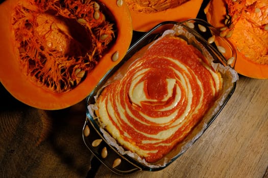 Homemade pumpkin pie cheesecake with piece of pumpkin. Orange dessert. vertical image. top view. PLACE FOR TEXT.