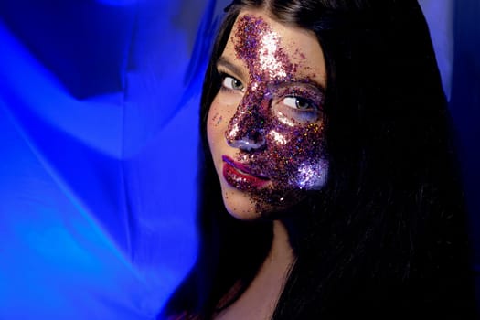 Festive makeup Fashion teen girl beauty women portrait of young model lovely fdecorated with shining glitter, people, beauty and cosmetics on blue background, glitter looks like Milky way