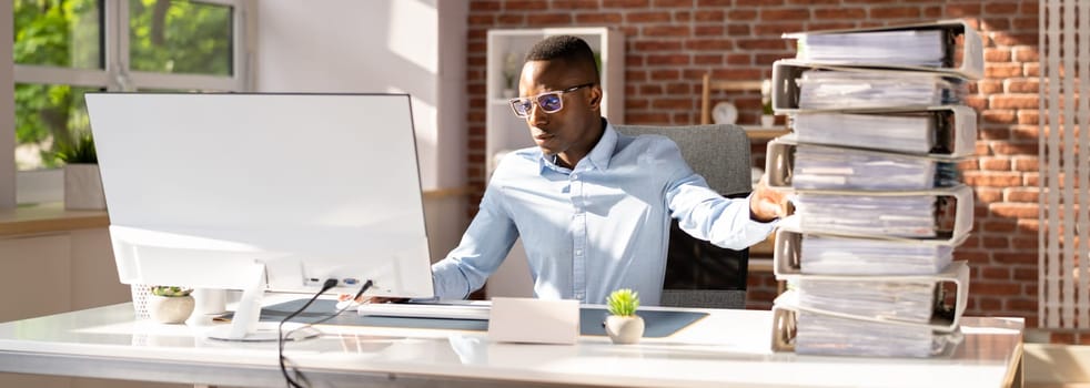 Businessperson Pushing Paper Documents Away And Working With Digital Documents On Computer Instead