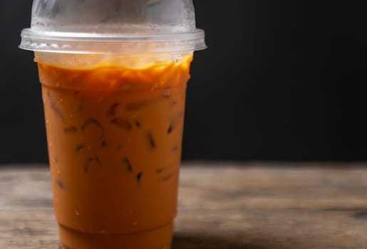 Tea thai, Ice tea milk or Ice milk tea, Sweet drink, Blurred black background