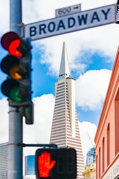 Bbroadway street sign in San Francisco, California, USA. Transamerica pyramid building in background.