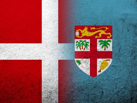 the Kingdom of Denmark National flag with The Republic of Fiji National flag. Grunge Background