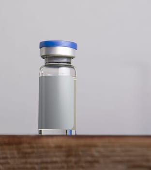 Single medical vial for injection isolated on gray background. Medicine and healthcare concept. mock-up series template ready for your design, label selection path included.