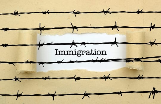 Immigration text against barbwire