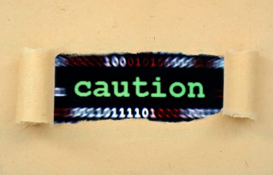 Caution text on ripped paper