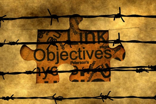Objectives puzzle concept against barbwire