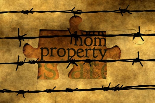 Property puzzle concept against barbwire