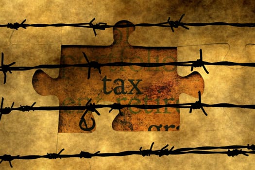 Tax puzzle concept against barbwire