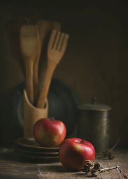 Kitchen still life with red apples and wooden plates.