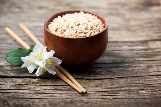 Rice and jasmine flower onrustic wooden table
